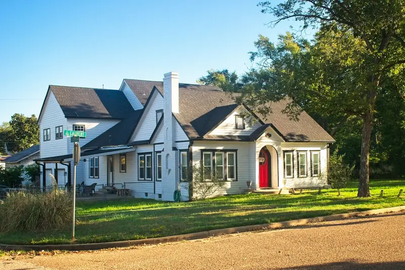 Older home on a sunny, tree-shaded street