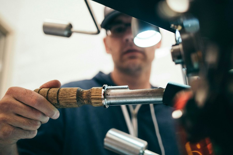 Close-up of a plumber’s hands working copper pipe with a torch in a residential setting